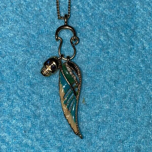 SKULL charm with red stone eyes on a wing charm holder adjustable chain necklace